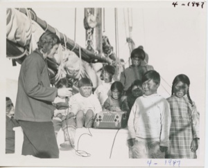 Image: Miriam and Polar Eskimo [Inuit] children grouped around recorder